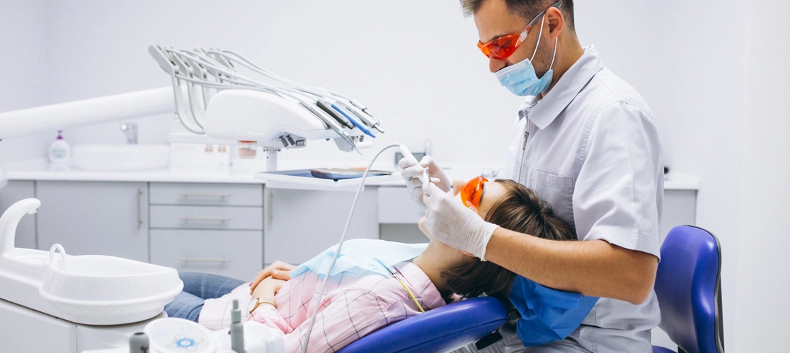 A dentist performs advanced dental treatment using modern equipment, ensuring precise and effective care.